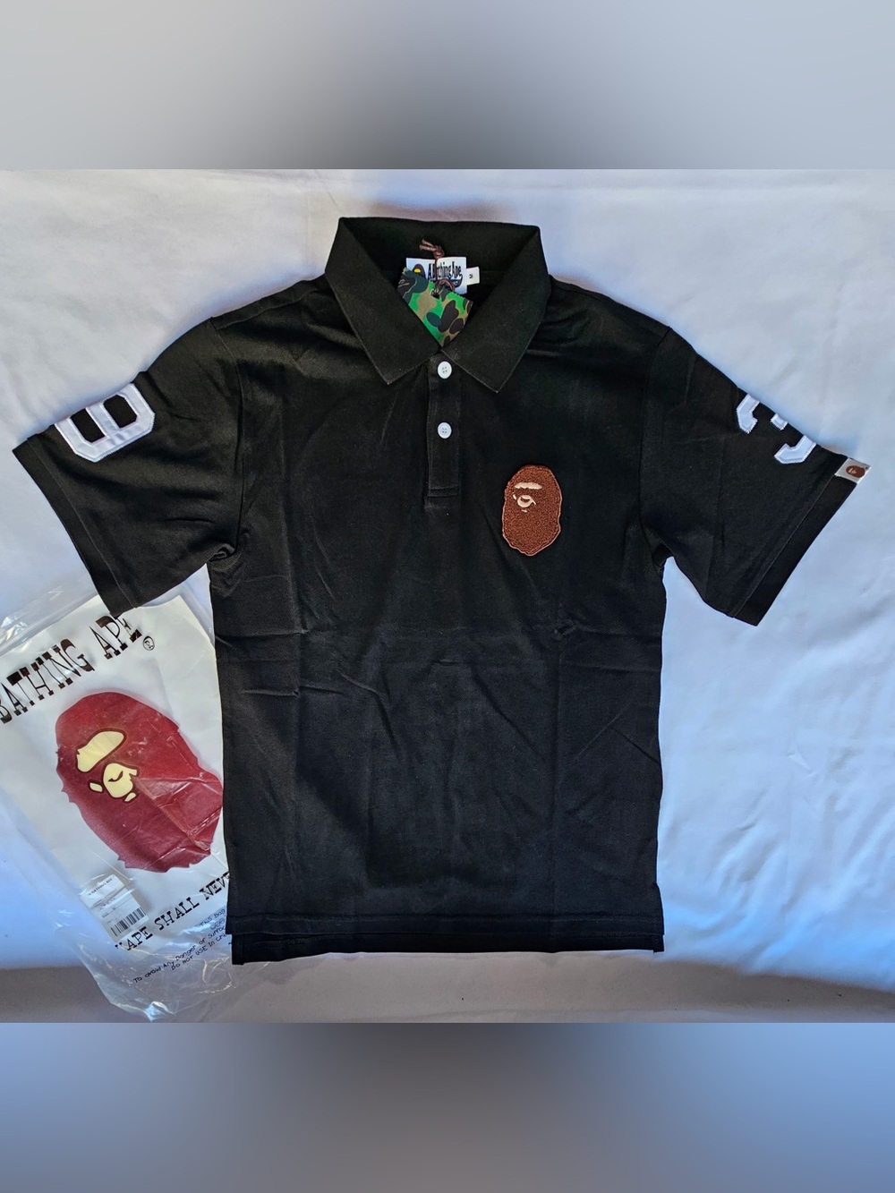 A Bathing Ape (BAPE) Black Polo with Ape Head Patch
